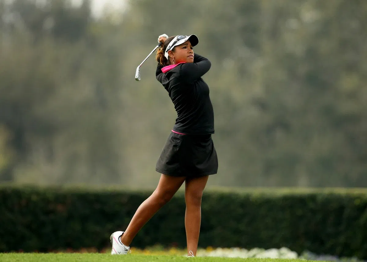 Ginger Howard completing her swing after hitting a golf ball
